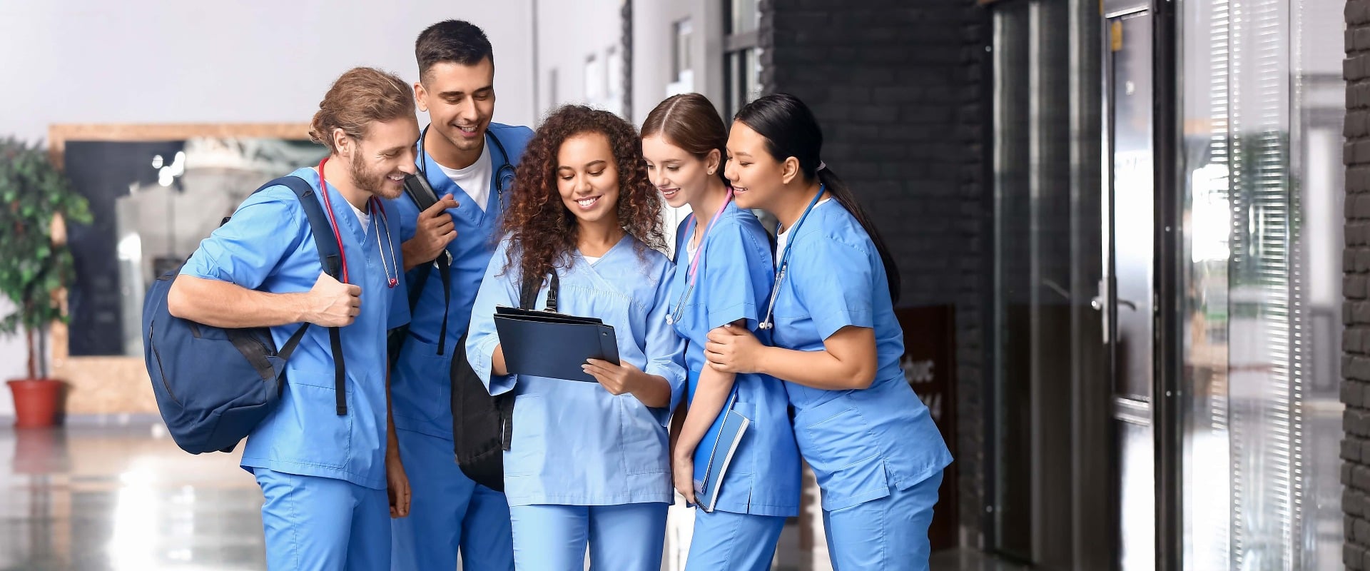 Group of students with clipboard in hall of medical university